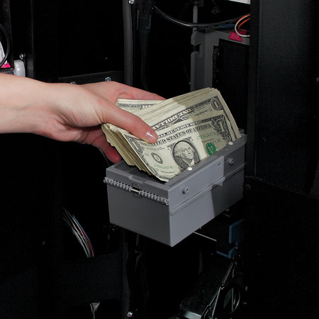 A vending operator retrieving cash that customers had paid with from their vending machine.