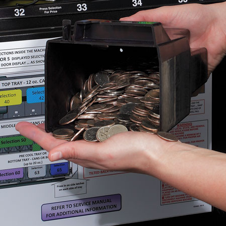 A vending operator retrieving coins that customers had paid with from their vending machine.