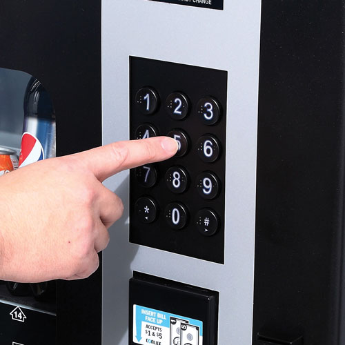 Customer purchasing a beverage from the CB500 Vending Machine by using the keypad.