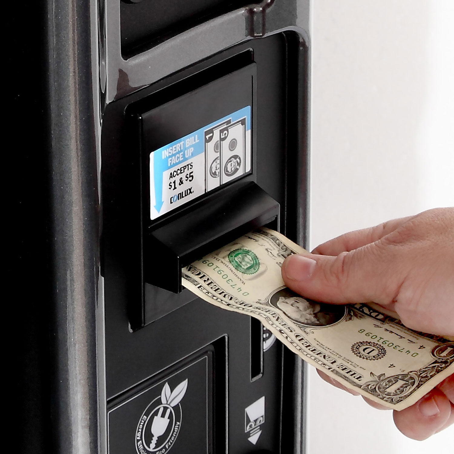 A customer purchasing a product with a $1 bill through a bill acceptor on a Selectivend vending machine.