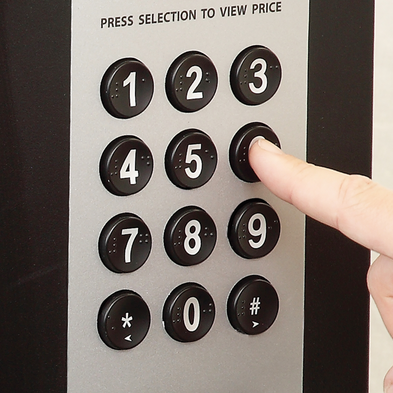 Customer utilizing the Braille keypad display on the SB256 Single Brew Pod Vendor.